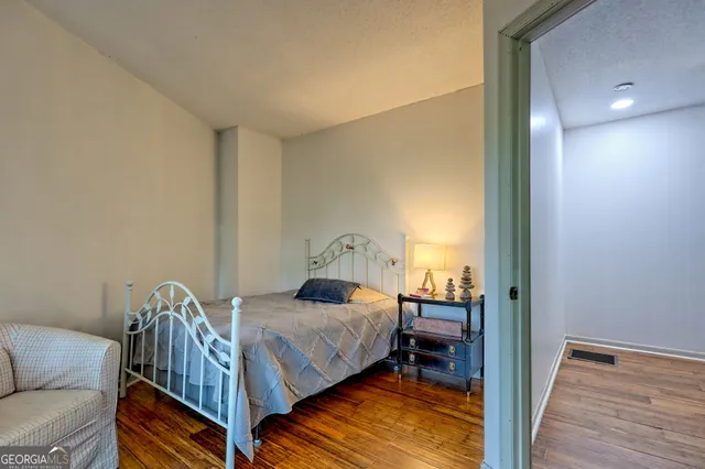 a view of a porch with wooden floor and floor to ceiling window