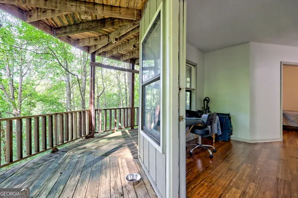 a view of a balcony with wooden floor
