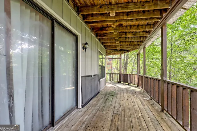 a view of porch with wooden floor and a floor to ceiling window