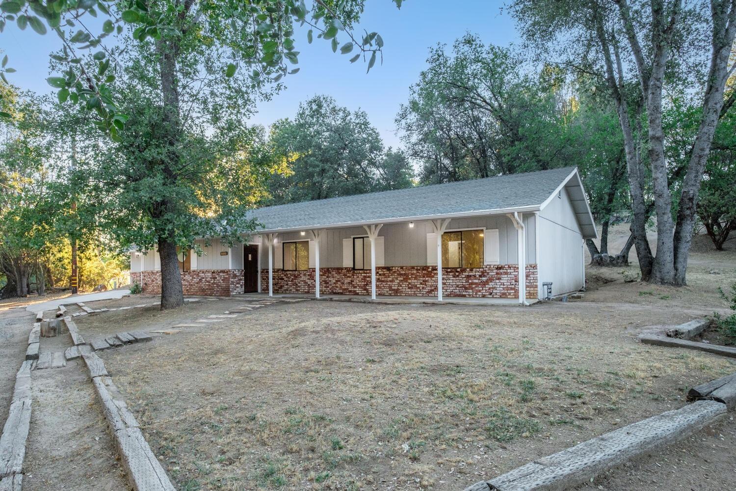 51202 Rusty Lane Oakhurst, CA 93644 - Photo 2 of 27 a view of a house with a yard