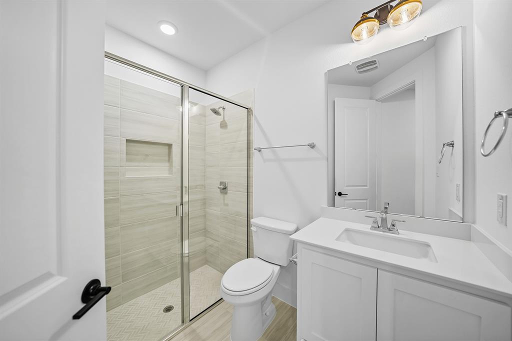 587 Mayfair Lane Frisco, TX 75033 - Photo 14 of 37 a bathroom with a sink toilet and shower
