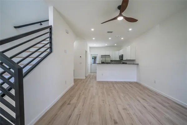 a view of kitchen with granite countertop cabinets and wooden floor