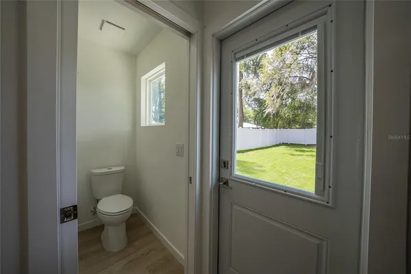 a bathroom with a toilet sink and window