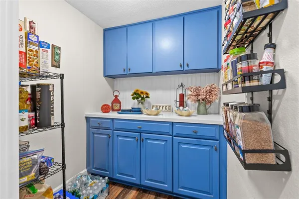 a utility room with lots of clutter and cabinets