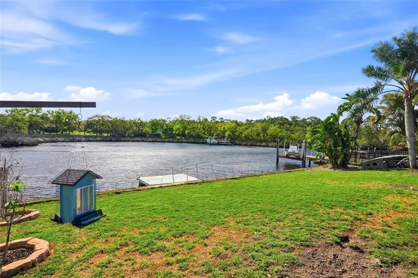 a view of a lake with houses in back