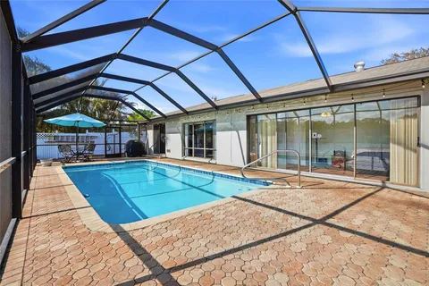 a view of a backyard with a swimming pool