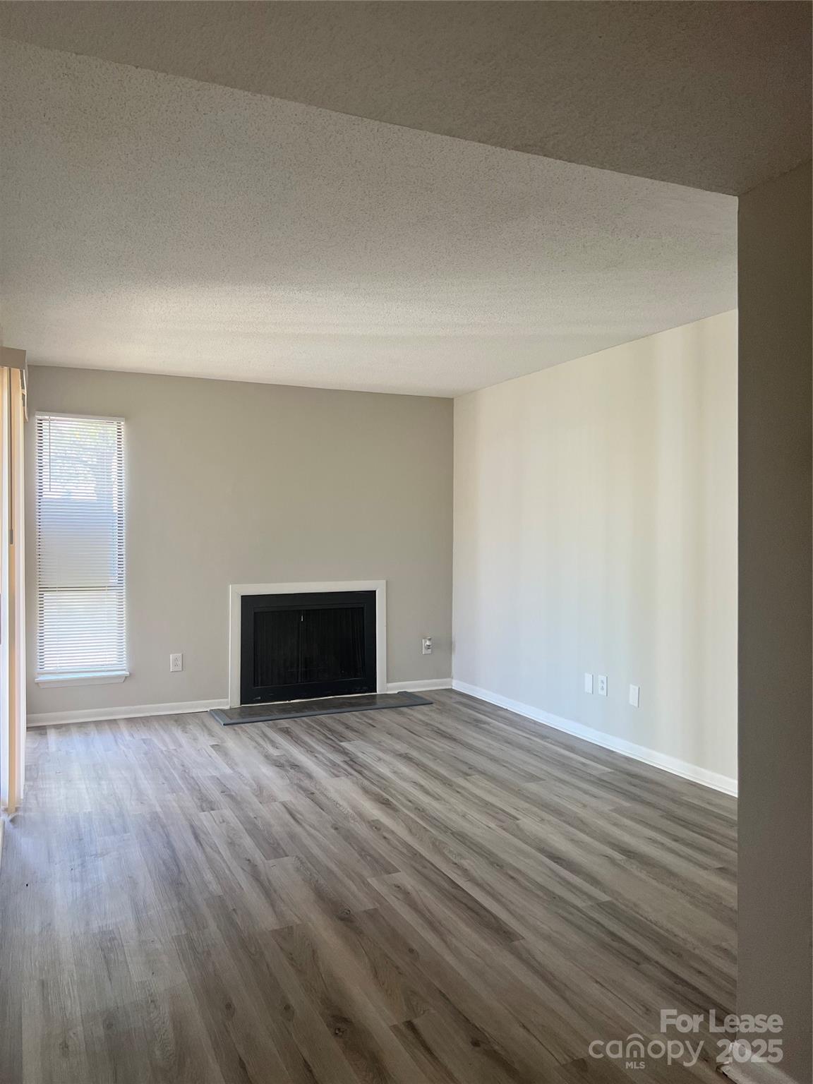 3215 Heathstead Place Charlotte, NC 28210 - Photo 2 of 10 a view of an empty room with wooden floor