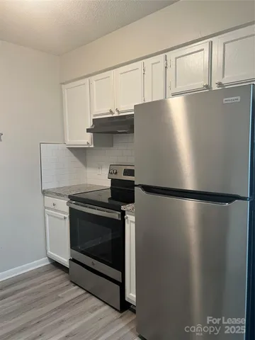 a white refrigerator freezer sitting in a kitchen