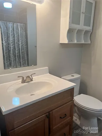 a bathroom with a sink a toilet and mirror