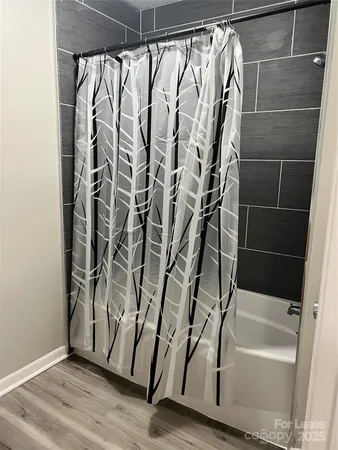 a bathroom with a bathtub and shower