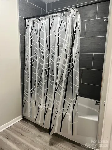 a bathroom with a bathtub and shower