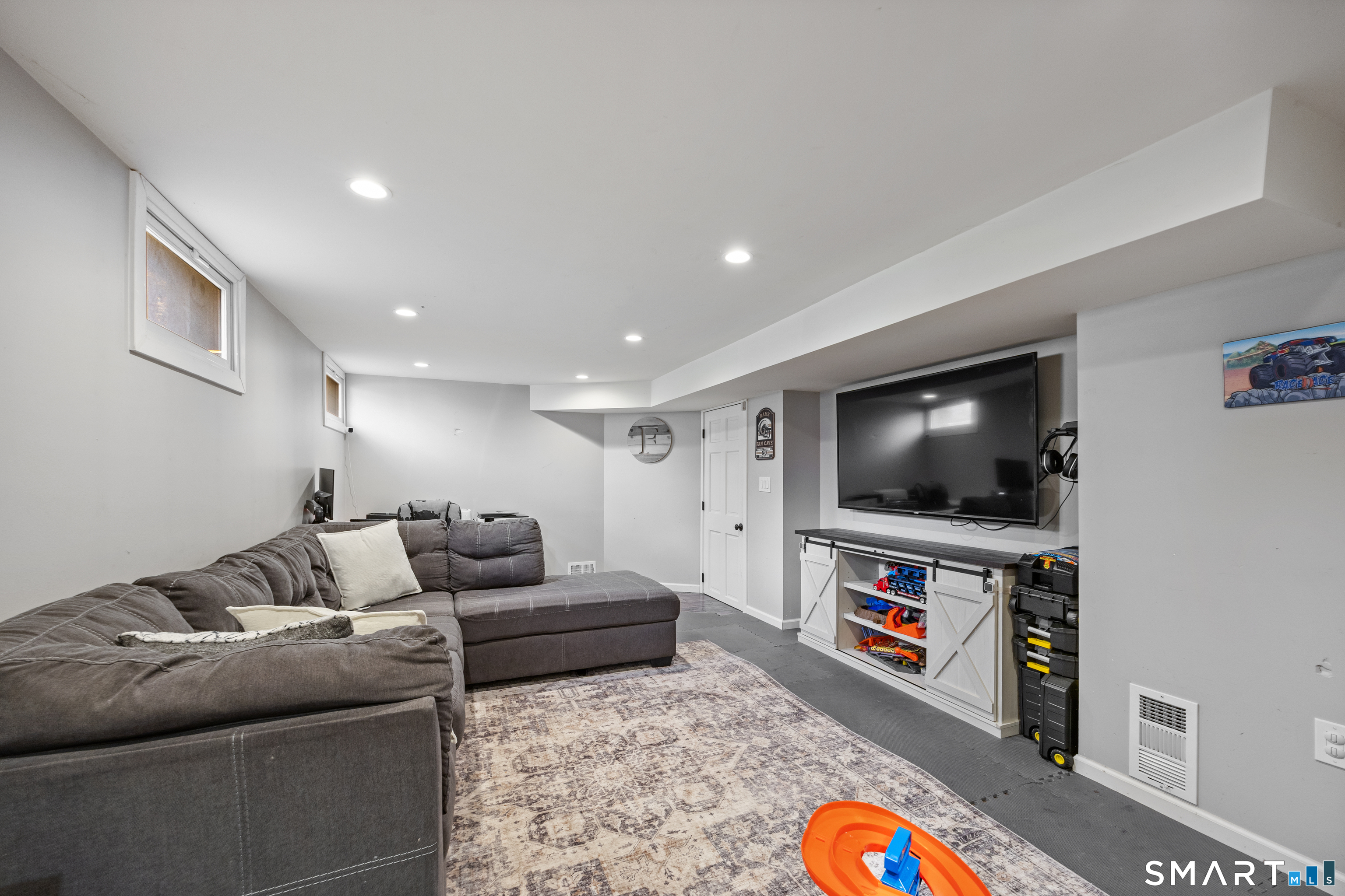 232 High Street Thomaston, CT 06787 - Photo 23 of 31 a living room with furniture and a flat screen tv