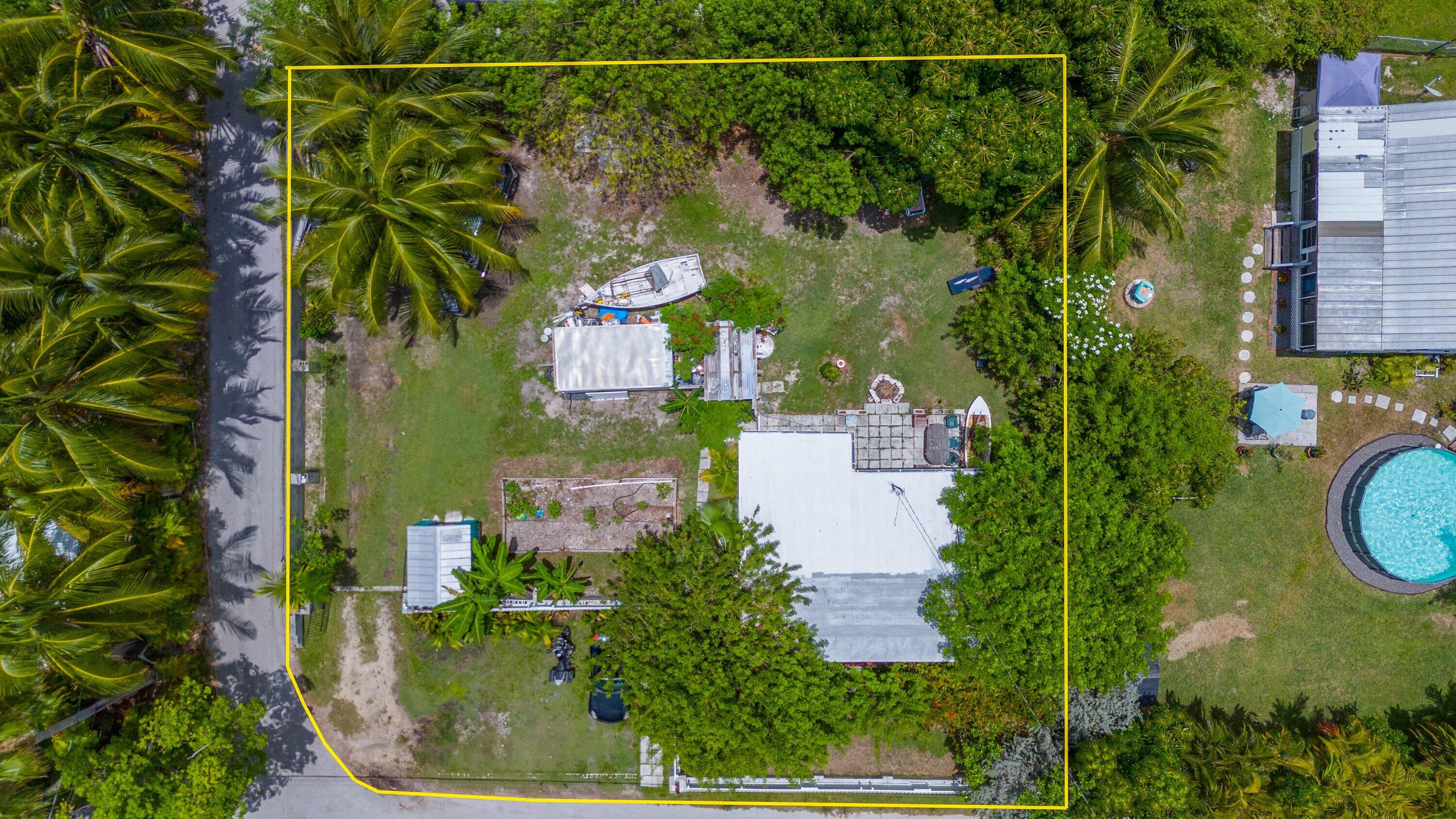 a aerial view of a house with a yard and lake view
