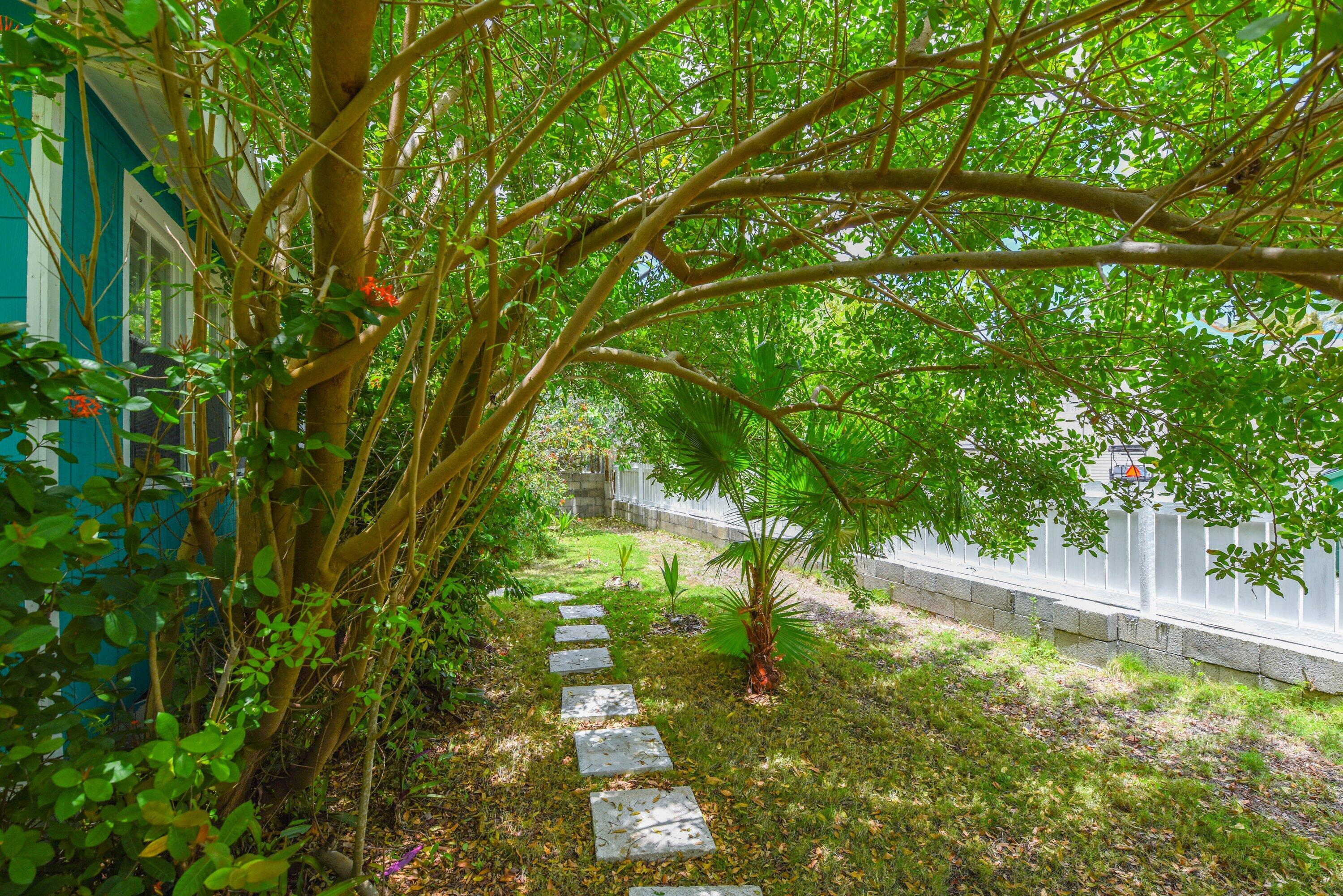 19910 Flamingo Road Sugarloaf, FL 33042 - Photo 16 of 26 a backyard of a house with lots of green space and trees all around