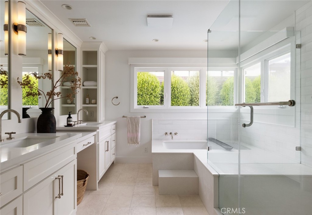 1120 Dolphin Terrace Corona del Mar, CA 92625 - Photo 11 of 48 a bathroom with a double vanity sink a large mirror and a bathtub