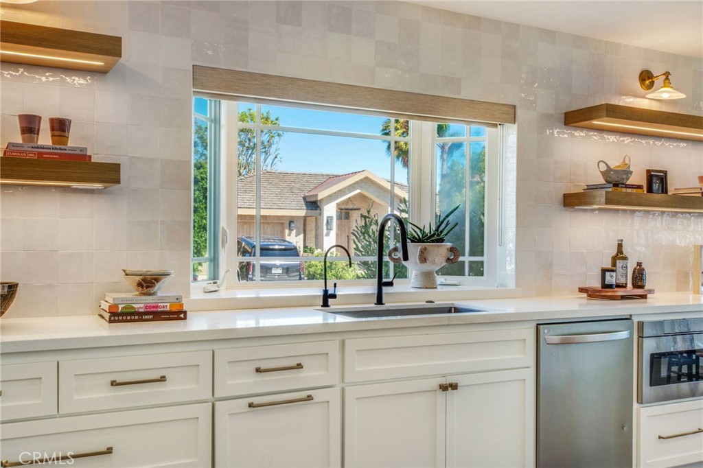 1120 Dolphin Terrace Corona del Mar, CA 92625 - Photo 15 of 48 a kitchen with a sink and a large window