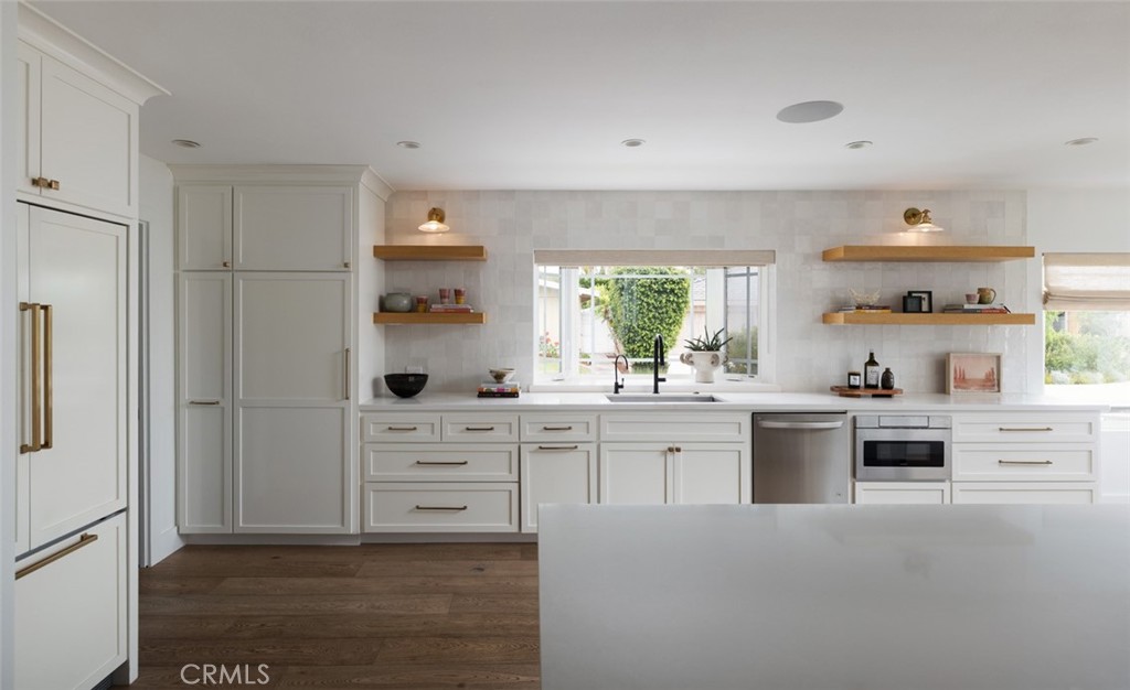 1120 Dolphin Terrace Corona del Mar, CA 92625 - Photo 17 of 48 a kitchen with white cabinets and stainless steel appliances