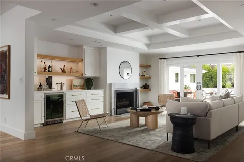 a living room with fireplace furniture and a large window