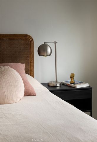 a kitchen with white cabinets and window