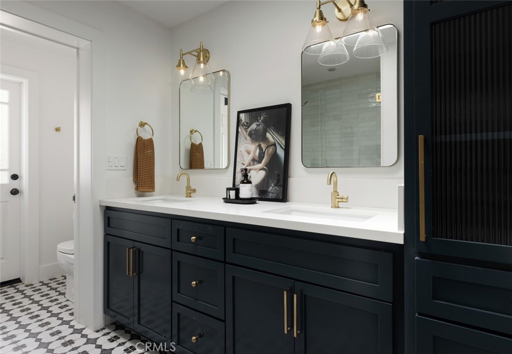 1120 Dolphin Terrace Corona del Mar, CA 92625 - Photo 26 of 48 a bathroom with a double vanity sink a toilet and a mirror
