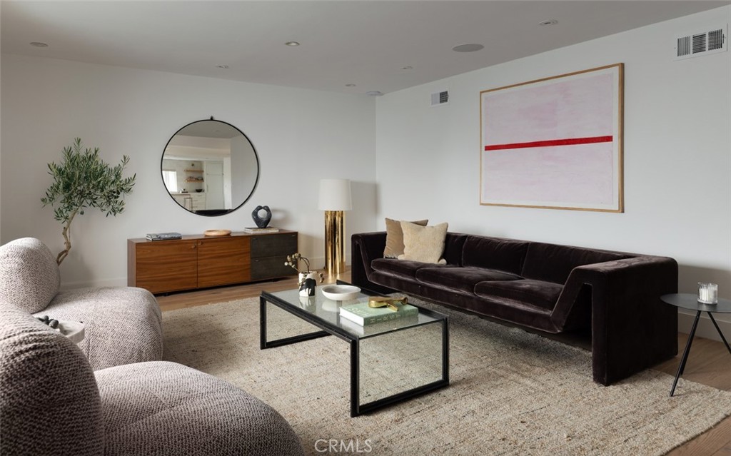 1120 Dolphin Terrace Corona del Mar, CA 92625 - Photo 29 of 48 a living room with furniture a mirror and a large window