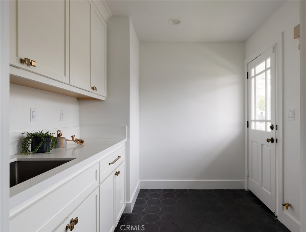 1120 Dolphin Terrace Corona del Mar, CA 92625 - Photo 40 of 48 a kitchen with a sink and cabinets