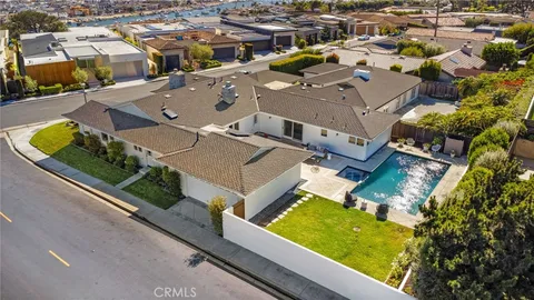 a bedroom with a bed a table and painting on the wall