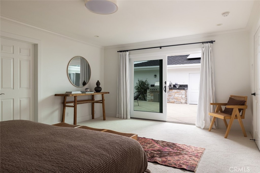 1120 Dolphin Terrace Corona del Mar, CA 92625 - Photo 9 of 48 a bedroom with a bed a table and painting on the wall