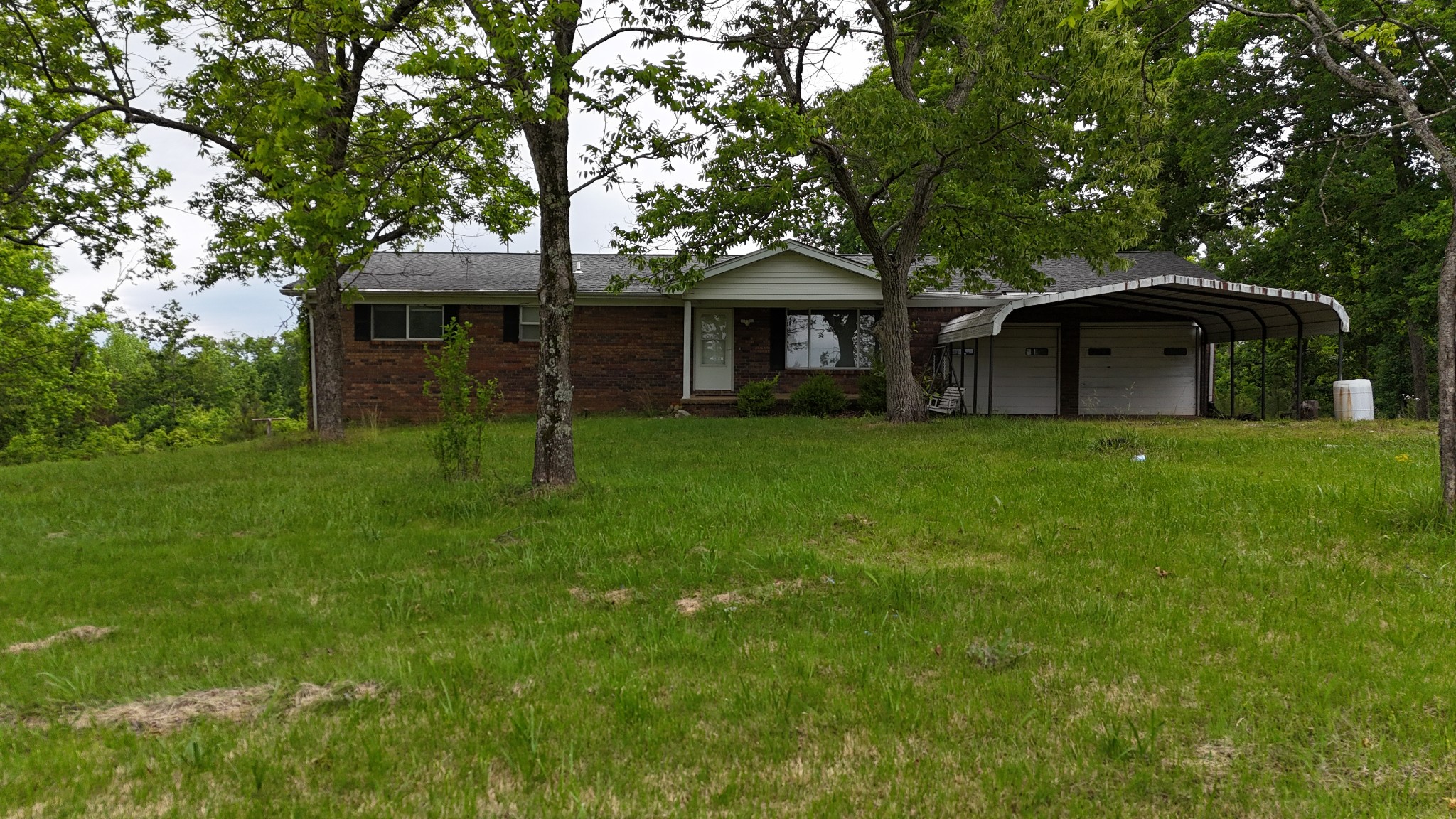 178 Lester Plunk Road Bethel Springs, TN 38315 - Photo 1 of 39 a front view of a house with a garden