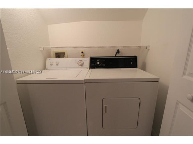 6761 Northwest 182nd Street, Unit 104 Hialeah, FL 33015 - Photo 6 of 12 a utility room with dryer and washer