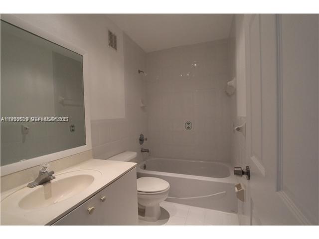6761 Northwest 182nd Street, Unit 104 Hialeah, FL 33015 - Photo 7 of 12 a bathroom with a sink and a mirror