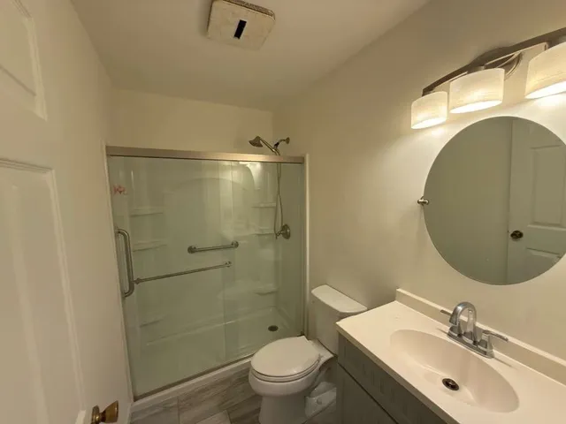 a view of empty room with wooden floor