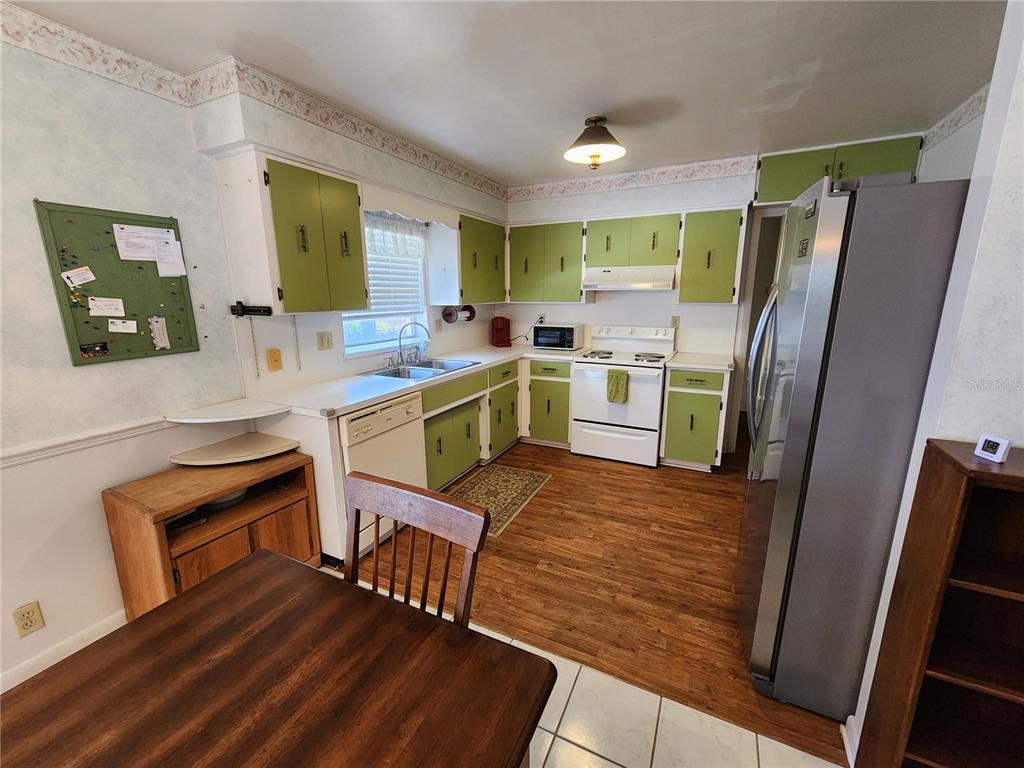 108 Lameraux Road Winter Haven, FL 33884 - Photo 12 of 27 a kitchen with a refrigerator and a stove top oven