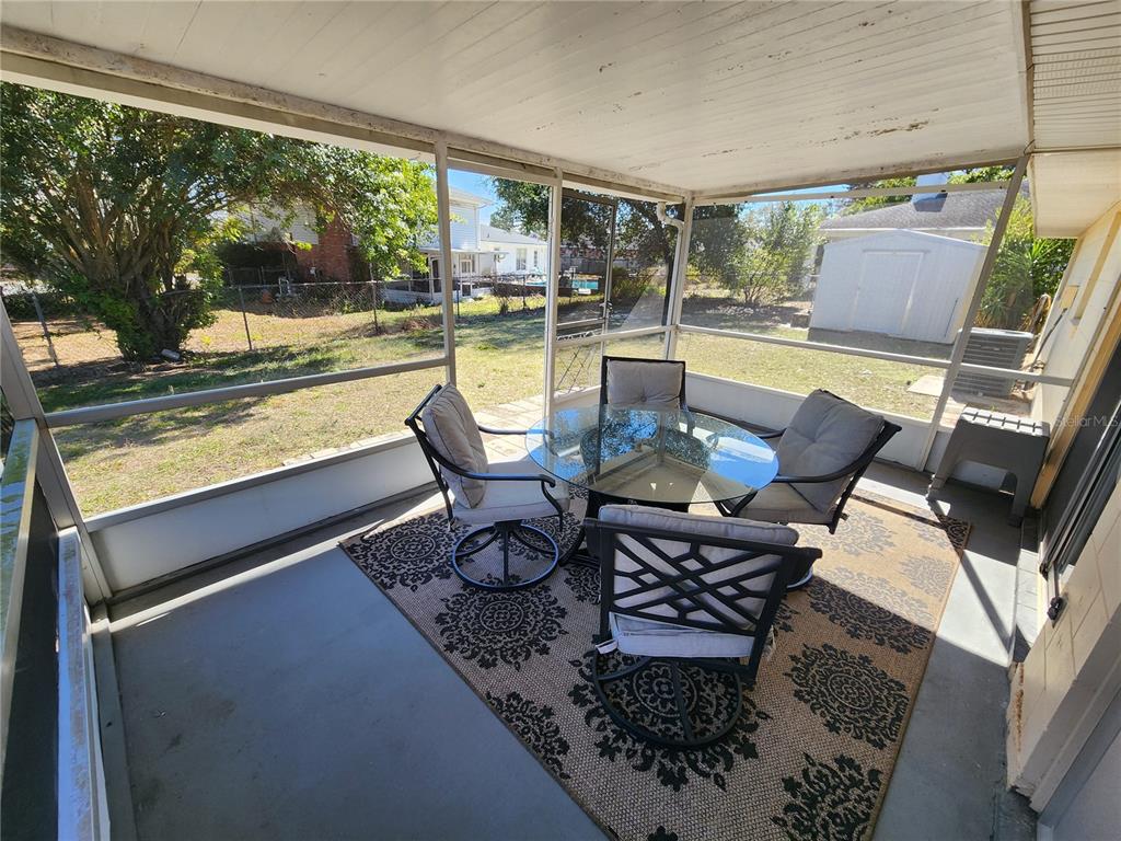 108 Lameraux Road Winter Haven, FL 33884 - Photo 23 of 27 a living room with patio furniture and a floor to ceiling window