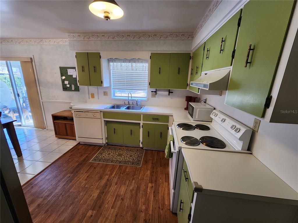 108 Lameraux Road Winter Haven, FL 33884 - Photo 9 of 27 a room with kitchen island a sink wooden floor and view living room