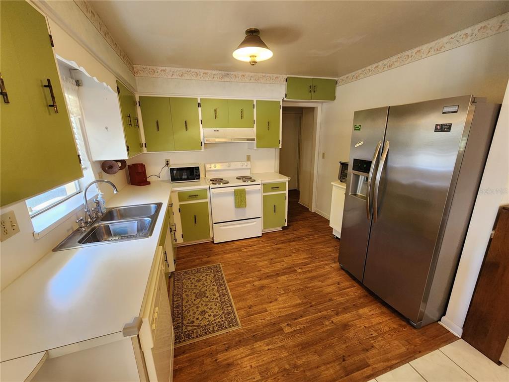 108 Lameraux Road Winter Haven, FL 33884 - Photo 10 of 27 a kitchen with stainless steel appliances granite countertop a refrigerator a stove and a sink