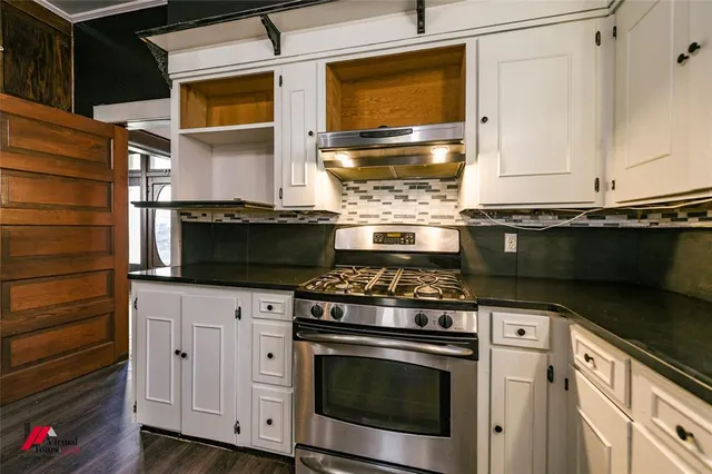 a kitchen with stainless steel appliances granite countertop a stove and a microwave
