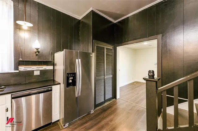 a kitchen with stainless steel appliances granite countertop a refrigerator and a stove
