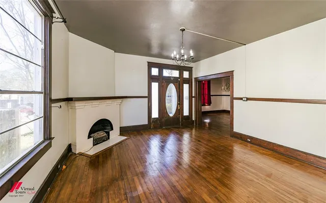 a view of livingroom with furniture wooden floor fireplace and window