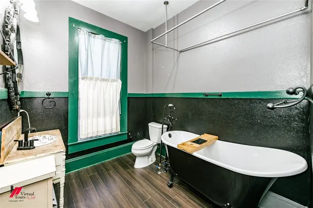 a open dining room with a sink a mirror and a rug