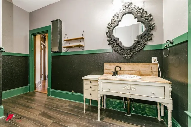 a bathroom with a sink mirror and vanity