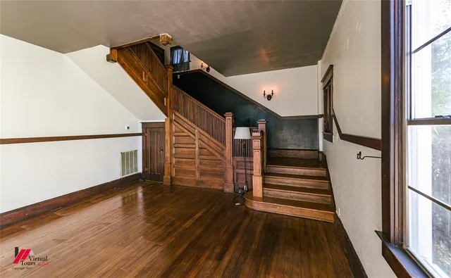 a view of entryway and hall with wooden floor