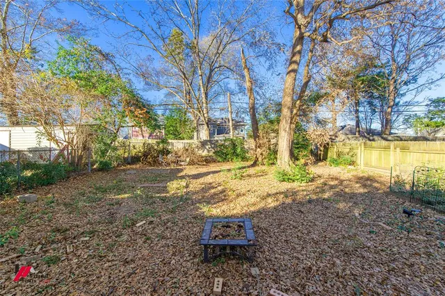 a backyard of a house with a yard and fountain
