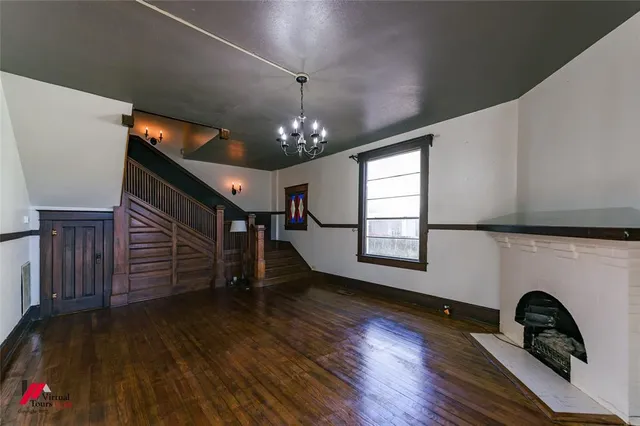 a view of a livingroom with wooden floor and a ceiling fan