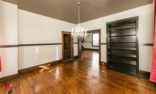 a view of a room with wooden floor and window