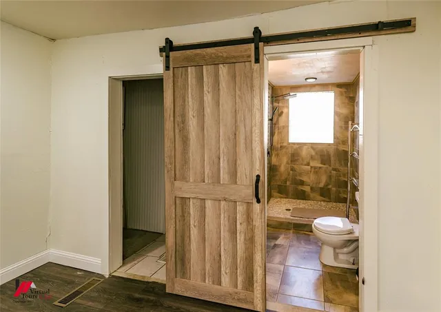 a bathroom with a shower and a toilet