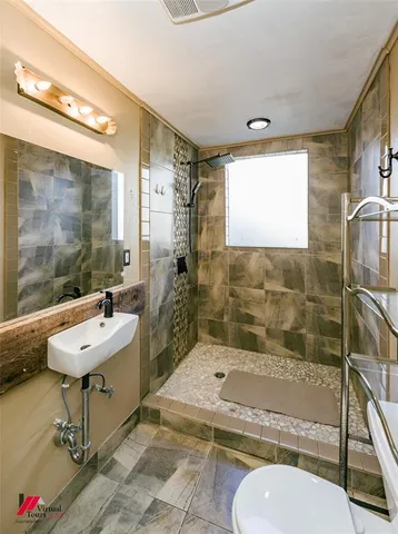 a bathroom with a sink mirror toilet and bathtub