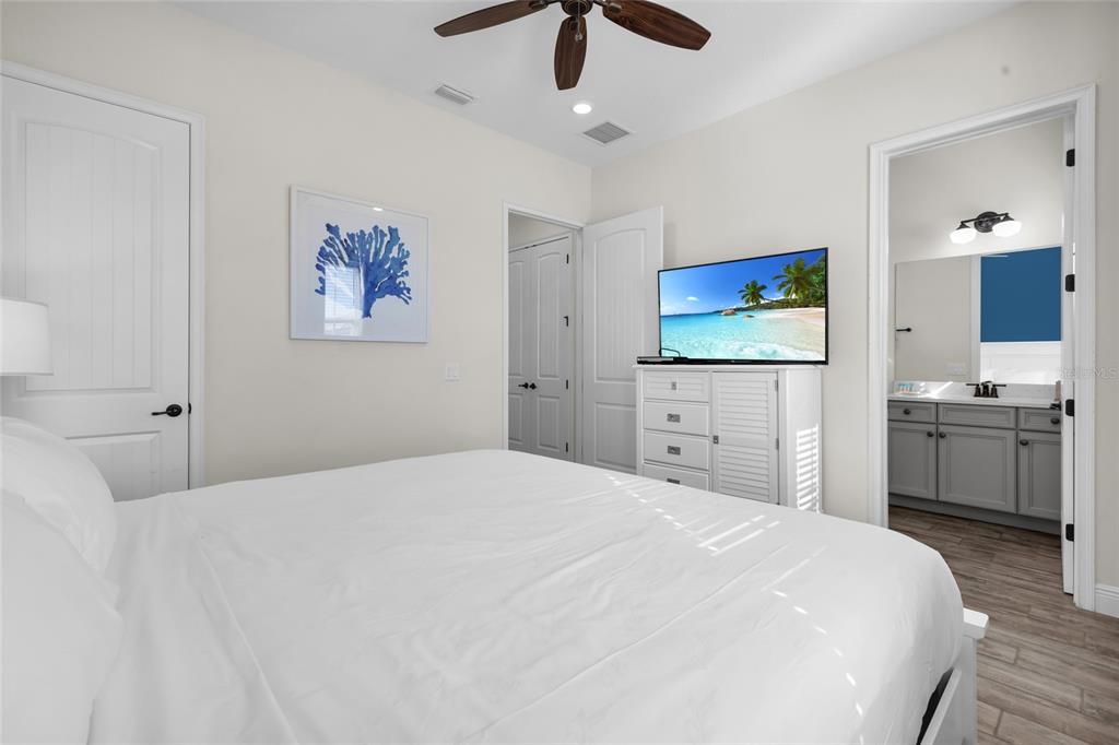 2972 Salted Rim Road Kissimmee, FL 34747 - Photo 22 of 39 a bedroom with a bed and a chandelier