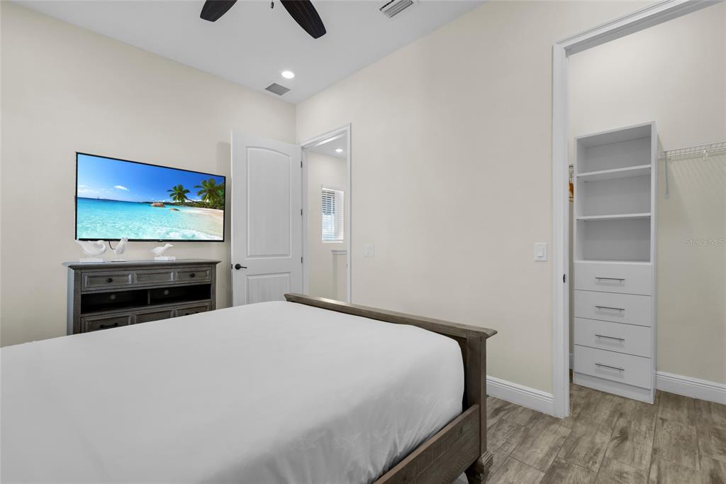2972 Salted Rim Road Kissimmee, FL 34747 - Photo 28 of 39 a bedroom with a bed and a flat screen tv
