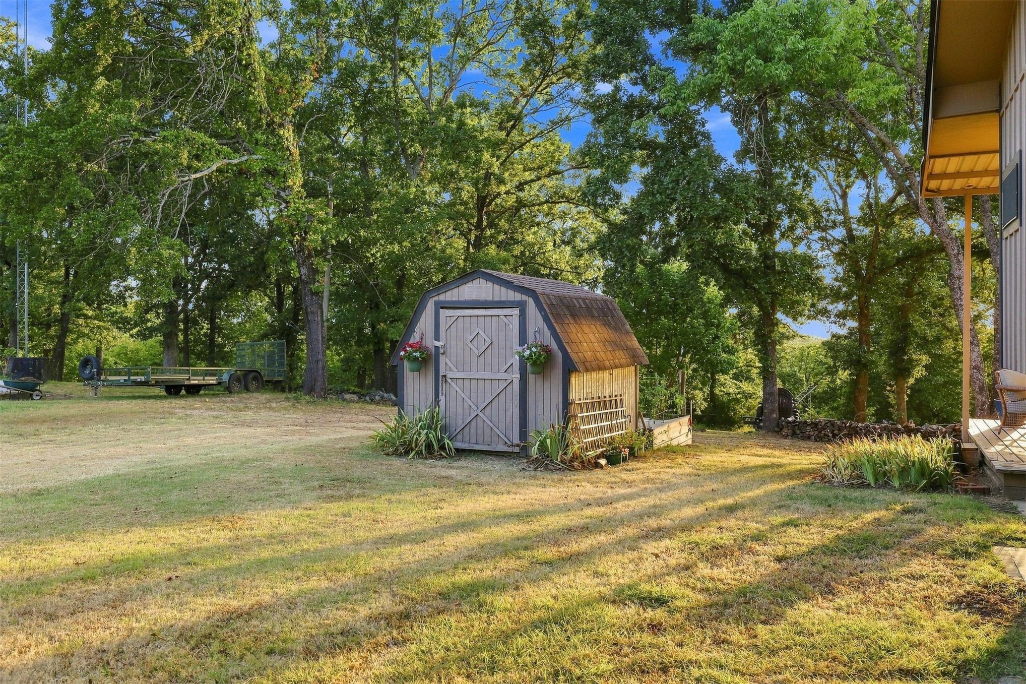 171 Woods Road Mead, OK 73449 - Photo 44 of 62 Wood-sided storage shed with a gambrel roof, featuring a double door entry